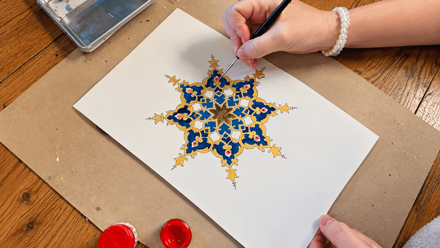 Hand painting floral artwork in the studio